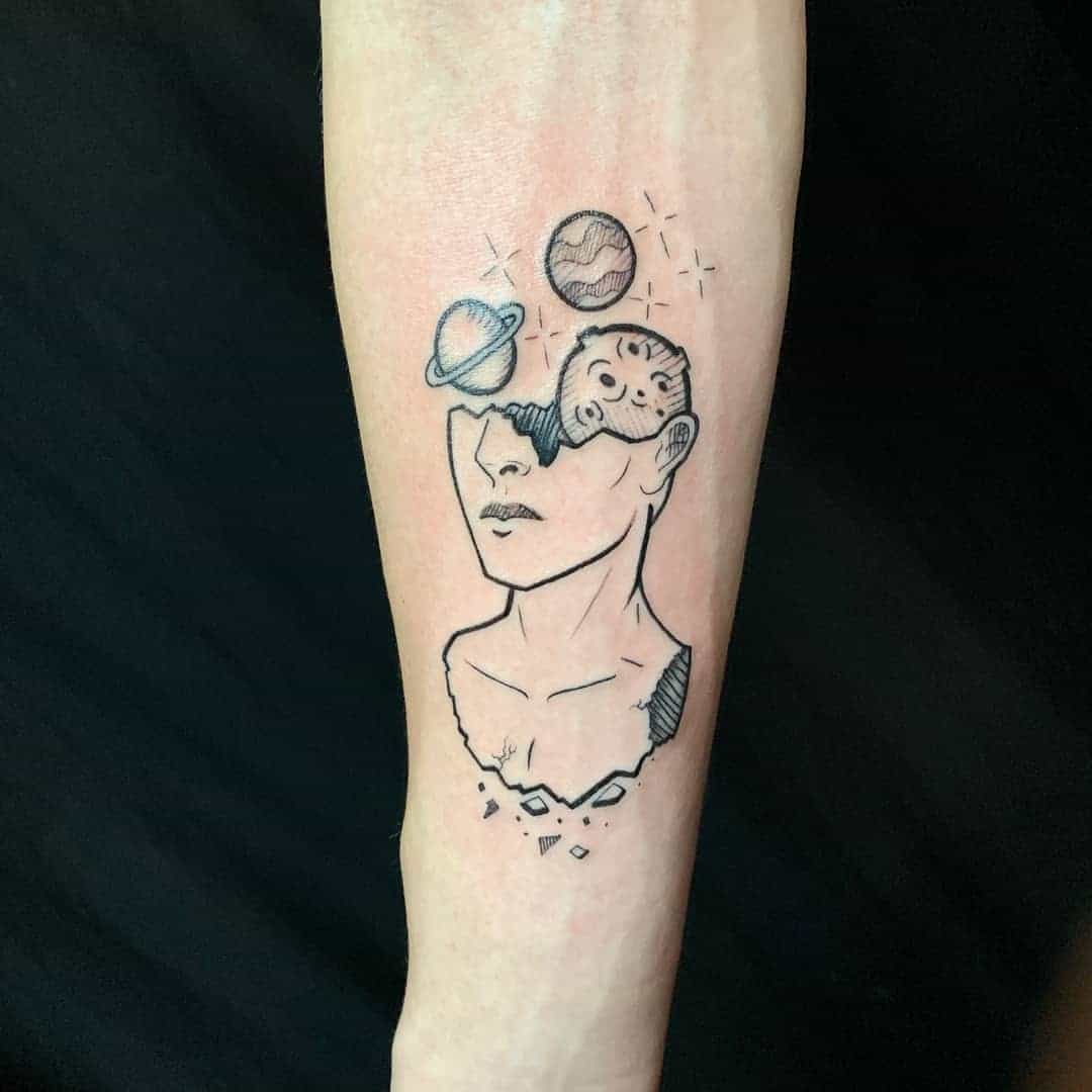 Tattoo of a woman with planets and stars above her head