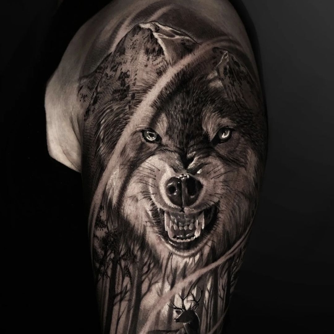 Detailed black and grey wolf tattoo on arm