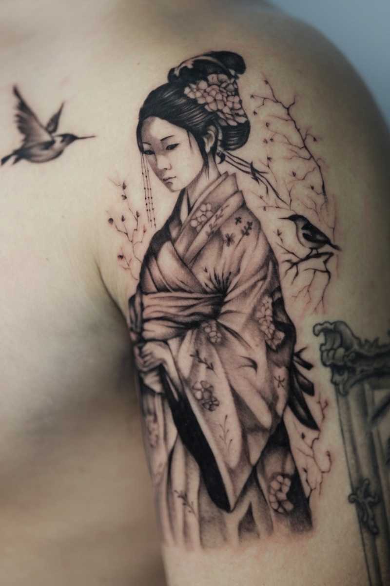 Tattoo of a woman in a kimono with birds on a shoulder