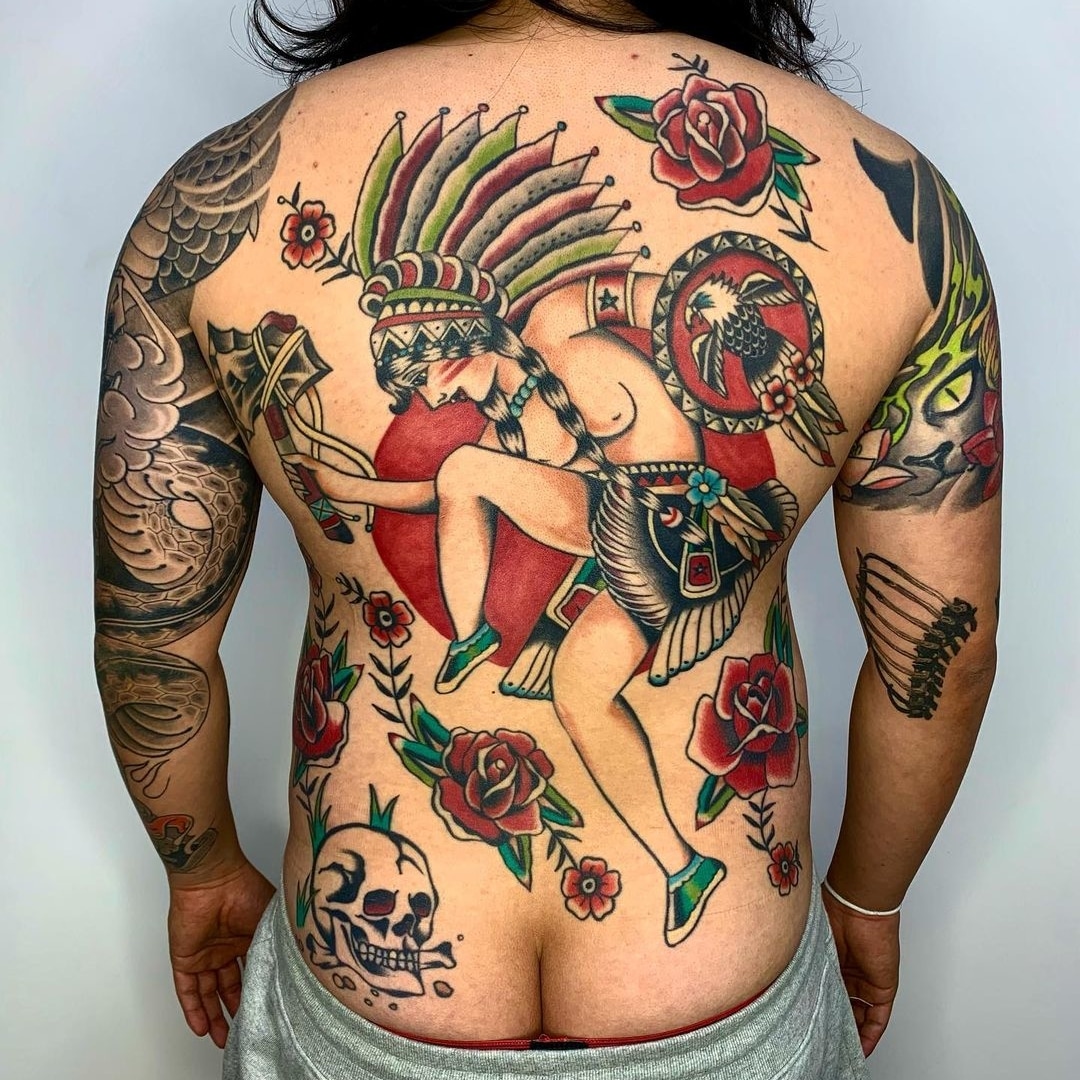 Colorful tattoo design featuring a warrior and roses on a person's back.