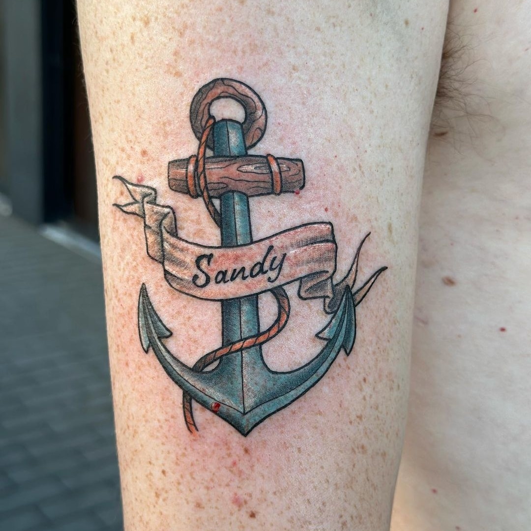 Colorful anchor tattoo with name Sandy on arm