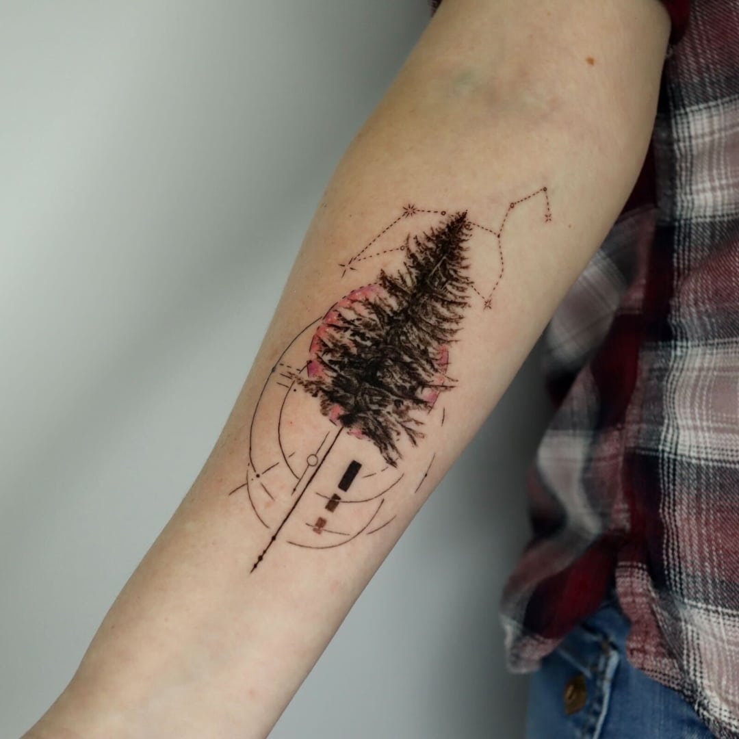 Tattoo design of a tree with geometric elements on arm
