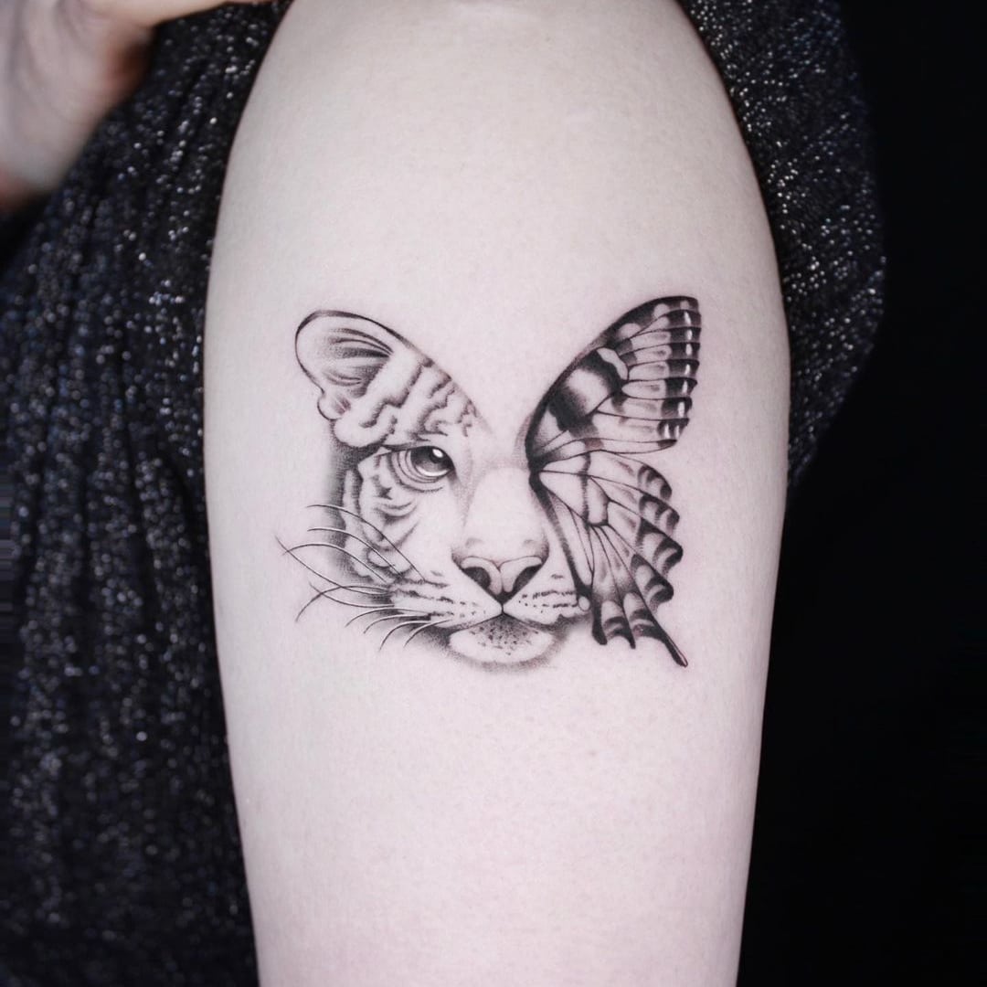Tattoo featuring a tiger's face merged with a butterfly.
