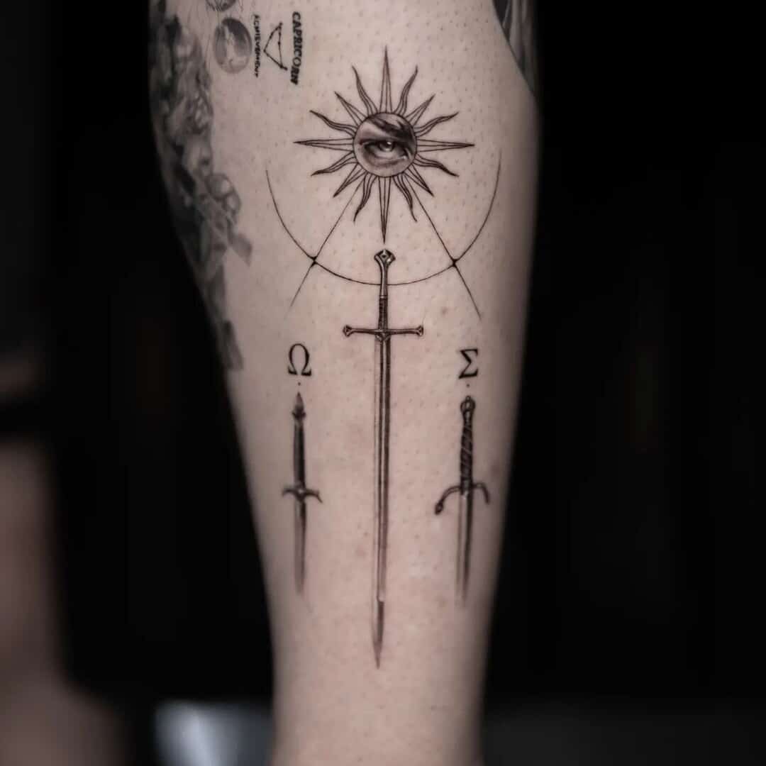 Detailed tattoo design featuring a sword and celestial elements