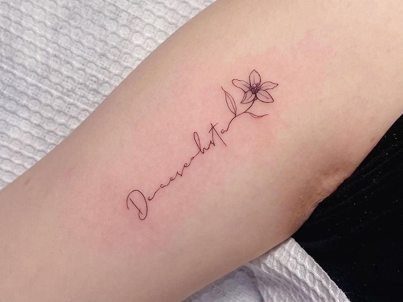 Minimalist floral tattoo design on skin